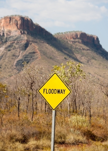 Floodway sign on outback road with mountains in background - Australian Stock Image