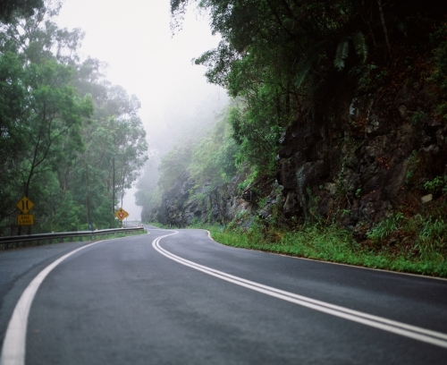 Foggy road next to cliff - Australian Stock Image