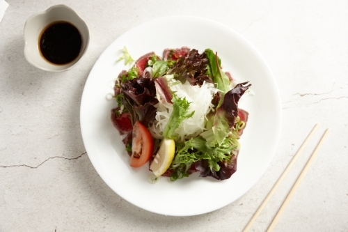 Beef tataki dish on table - Australian Stock Image