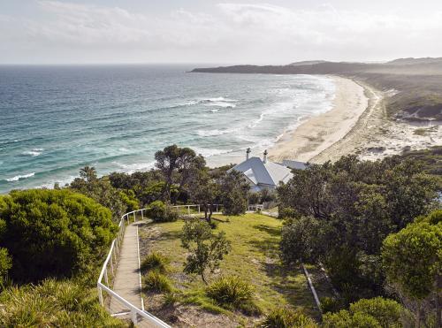 Footpath leading  to cottage on cliff above beach - Australian Stock Image