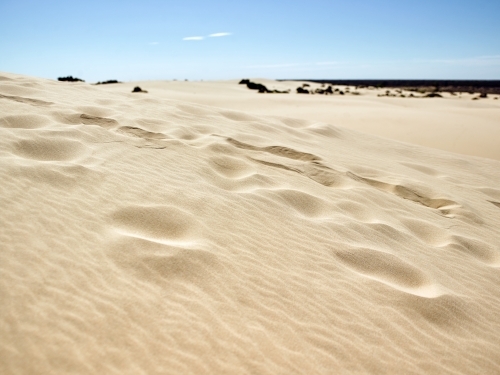 Footprints leading up a sandhill in remote region