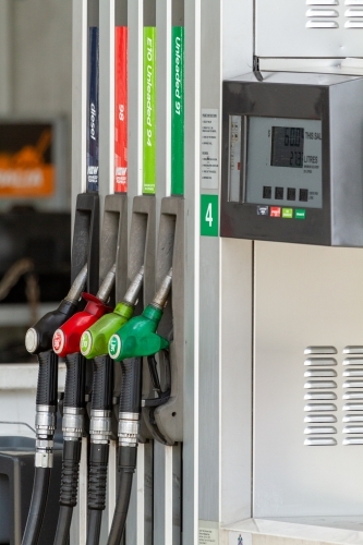 Four fuel nozzles at petrol pump bowser. - Australian Stock Image