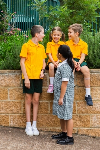 Four primary school friends laughing together