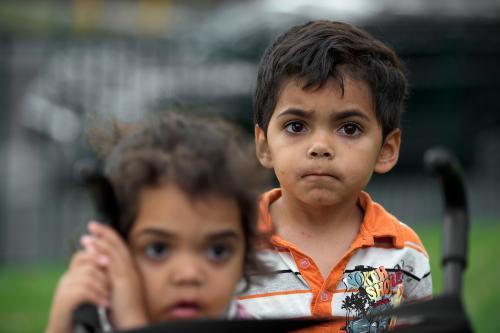 Four year Old Aboriginal Boy With Girl in Foreground - Australian Stock Image