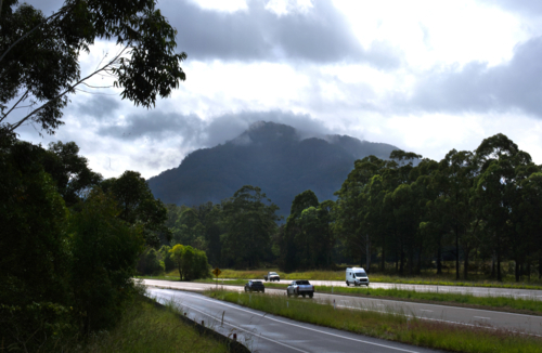 Freeway merge with mountain, mists and sun - Australian Stock Image