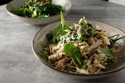 Fresh bowls of pasta on table - Australian Stock Image