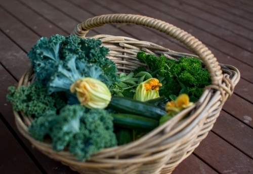 Fresh garden produce in wicker basket - Australian Stock Image