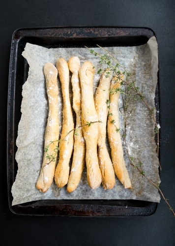 Fresh home baked bread sticks with thyme and salt.