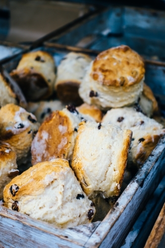Fresh scones in a rustic wooden box. - Australian Stock Image
