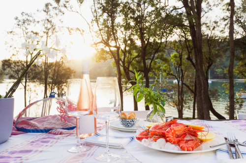 Fresh seafood on ice and rose wine with a water view - Australian Stock Image