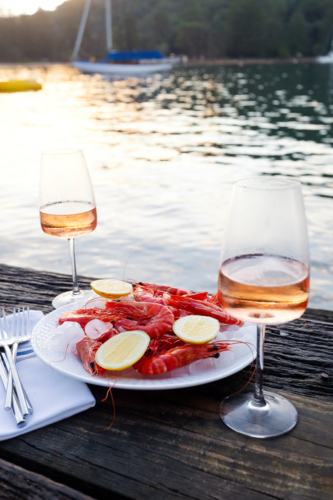 Fresh seafood on ice and rose with a water view - Australian Stock Image
