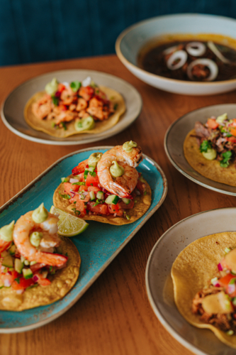 Fresh Shrimp Tacos With Colourful Toppings Served on Wooden Table - Australian Stock Image