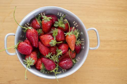 Fresh Strawberries in metal colander - Australian Stock Image