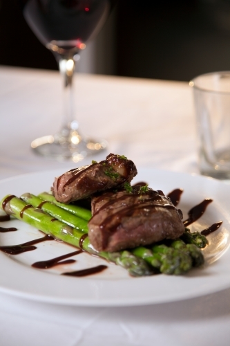 Freshly cooked steak on a plate with asparagus - Australian Stock Image
