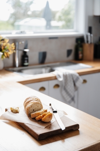 Freshly sliced bread in country kitchen - Australian Stock Image