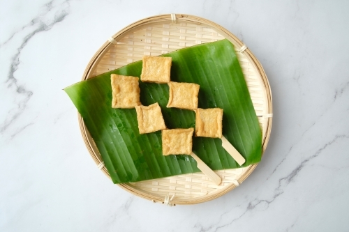 Fried tofu cubes on a skewer. - Australian Stock Image