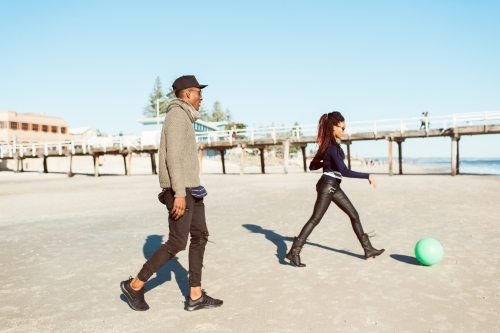 Friends playing on the beach - Australian Stock Image
