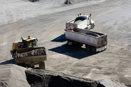 Front end loader loading a truck in mine - Australian Stock Image