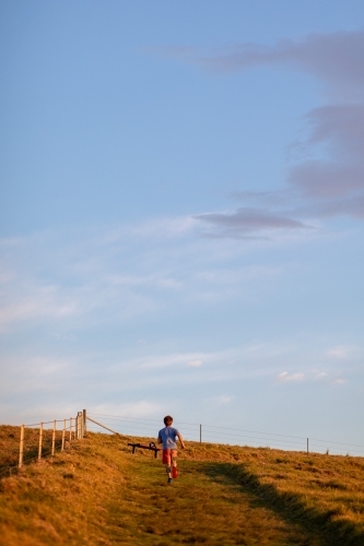 Full Length of Man Running up Hillside - Australian Stock Image