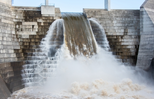 Full weir overflowing with water - Australian Stock Image