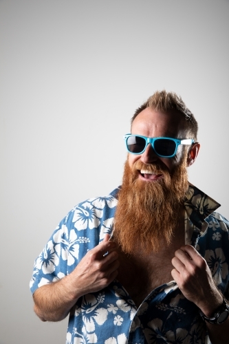 Funky man in a blue floral shirt posing for photographs - Australian Stock Image