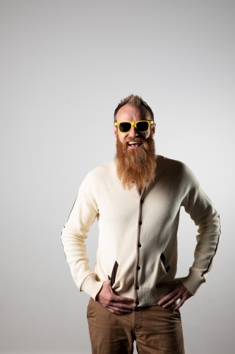 Funky man posing for photographs, wearing a beige shirt - Australian Stock Image