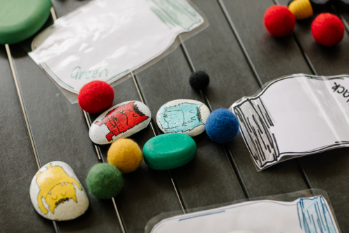 Funny looking monsters painted acrylic on pebbles. - Australian Stock Image