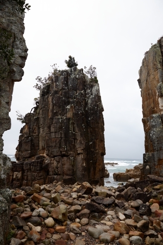 Gap between coastal rocks on overcast morning - Australian Stock Image