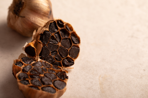 Garlic bulb sliced in half showing cloves - Australian Stock Image