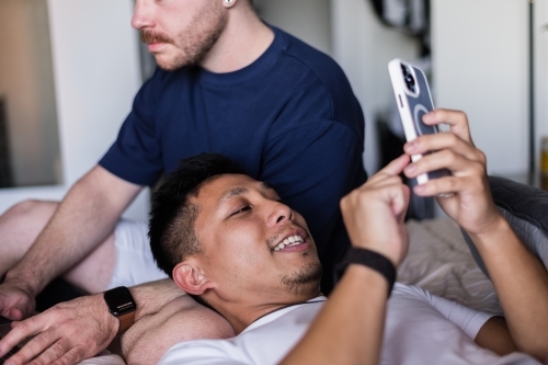 Gay couple hanging out at home - Australian Stock Image