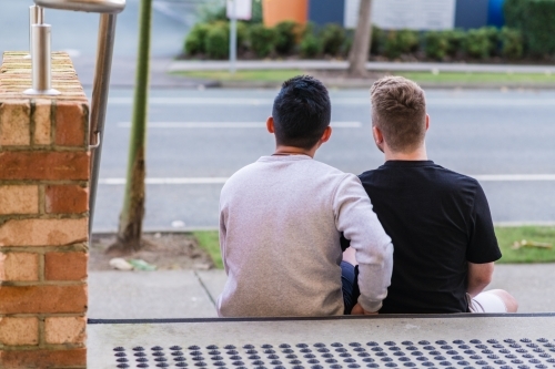 gay men sitting outside their apartment building - Australian Stock Image