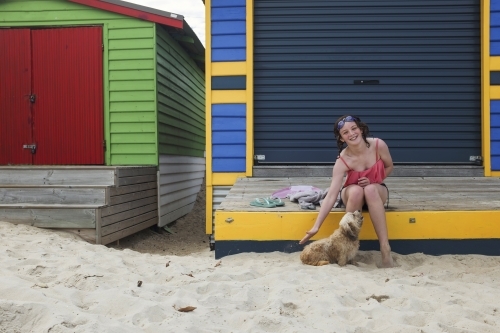 Girl at colourful beachbox - Australian Stock Image