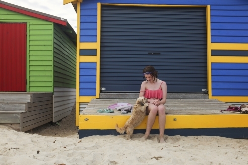 Girl at colourful beachbox - Australian Stock Image