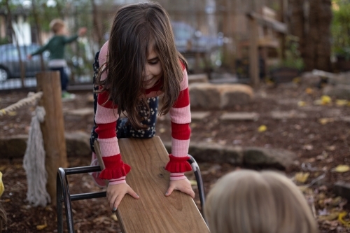 Girl child on a see-saw - Australian Stock Image