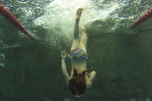 Girl diving in a pool - Australian Stock Image