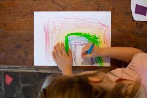 Girl drawing in early education setting - Australian Stock Image