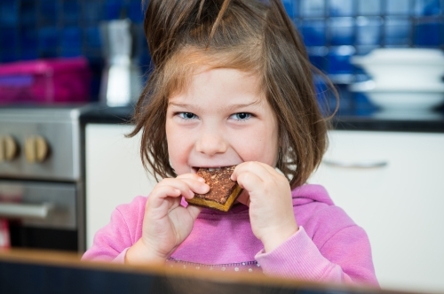 Girl enjoys home cooked treat - Australian Stock Image