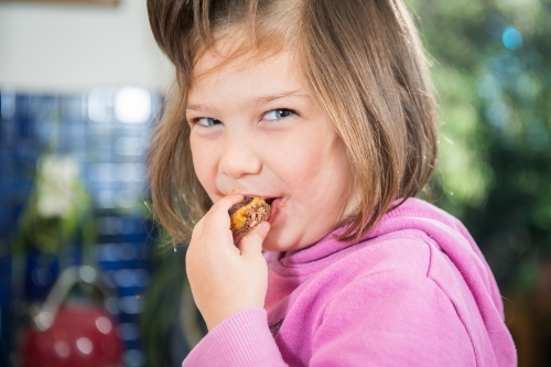 Girl enjoys home cooked treat - Australian Stock Image