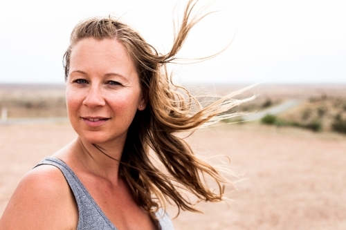 Girl in outback with hair blowing in the wind - Australian Stock Image