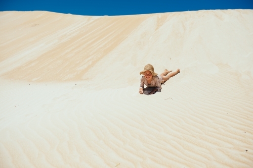 Girl laying in the sand dunes - Australian Stock Image
