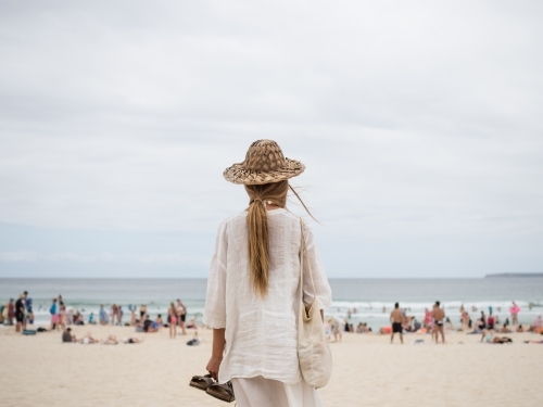 Girl looking on to busy Bondi beach
