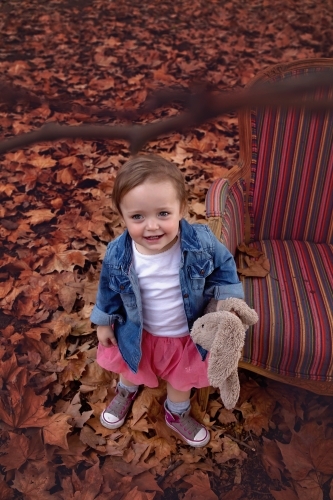 Girl Looking Up in Autumn Leaves - Australian Stock Image