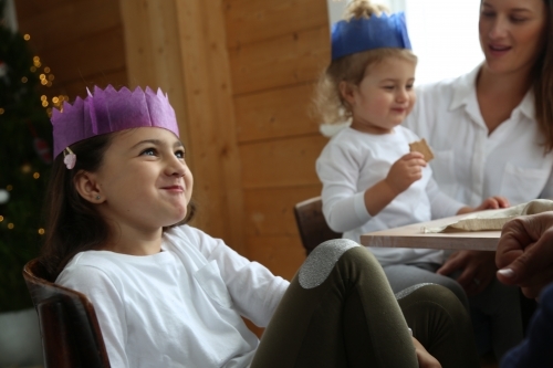 Girl looking up smiling in Christmas hat - Australian Stock Image