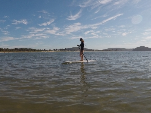 Girl on a stand up paddle board - Australian Stock Image