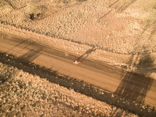 Girl on horse on outback road - Australian Stock Image