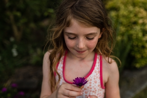 Girl outside with flowers - Australian Stock Image