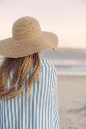 Girl overlooking the ocean at sunset - Australian Stock Image