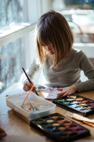 Girl painting with watercolour - Australian Stock Image