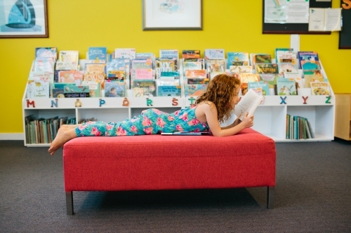 Girl reading a book at the Library - Australian Stock Image