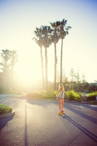 Girl Riding a Skateboard at Sunset - Australian Stock Image